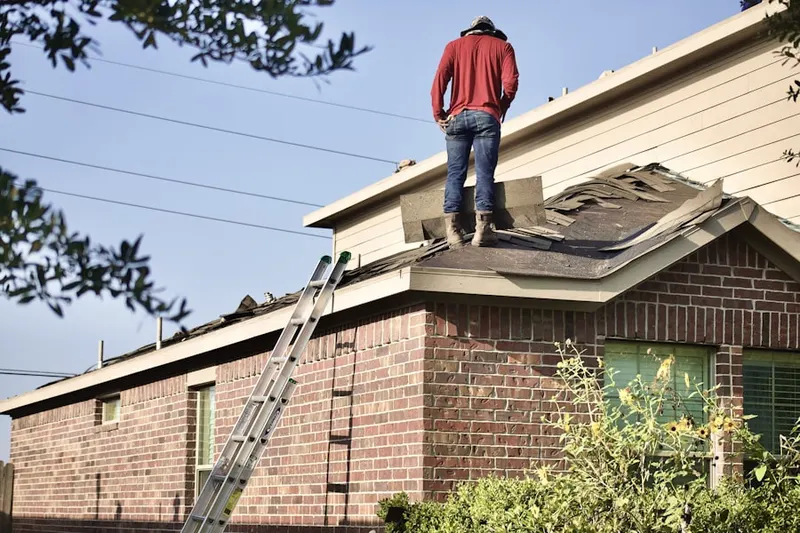 Professional roofer working on a residential roof in Wooster